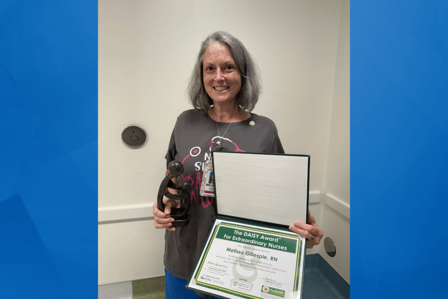 An image of Melissa Gillespie holding her award.