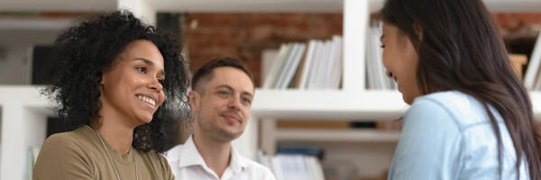 Two patients seated and conversing with seated counselor