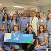 Group of health care providers pictured with TriClip surgical device